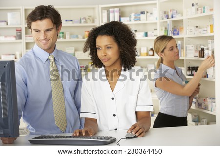 Nurse working on computer in pharmacy