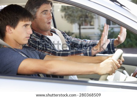 Nervous Father Teaching Teenage Son To Drive