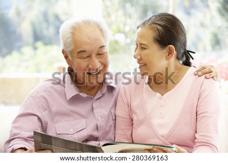 Senior asian couple reading magazine