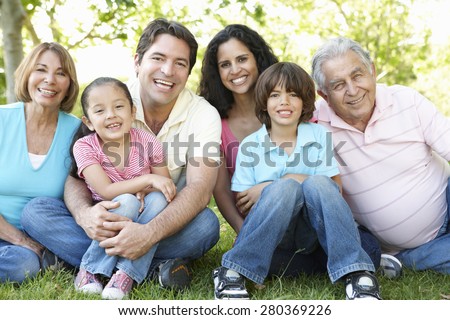 Multi Generation Hispanic Family Standing In Park