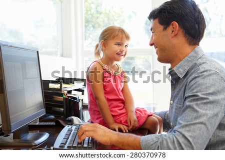 Father working in home office with daughter