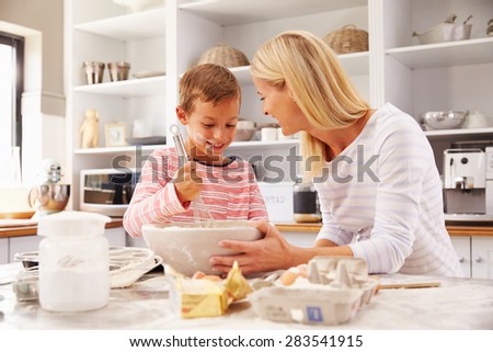 Mother and son baking together at home