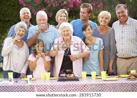 Large Family Group Celebrating Birthday Outdoors