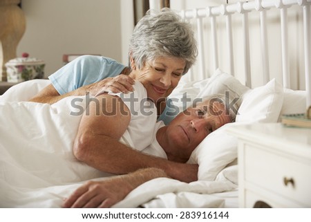 Senior Man Having Difficulty In Sleeping In Bed With Wife