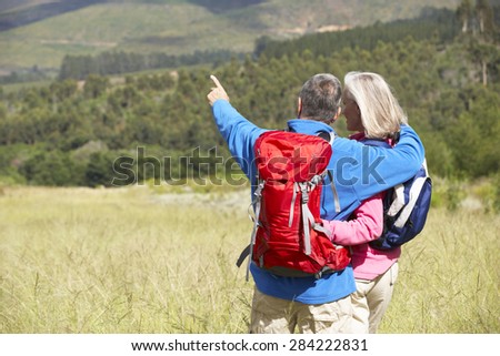 Senior Couple On Hike Through Beautiful Countryside
