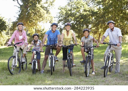 Three Generation Family On Cycle Ride In Countryside