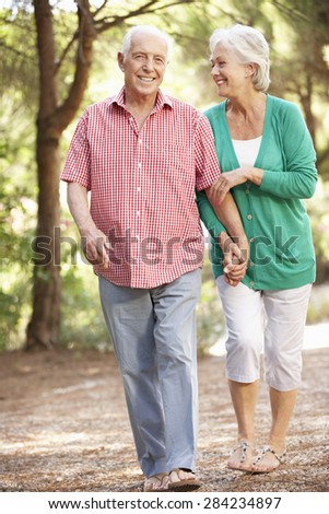 Senior Couple Walking In Countryside Together
