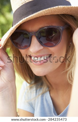 Head And Shoulders Portrait Of Smiling Woman With Sun Hat