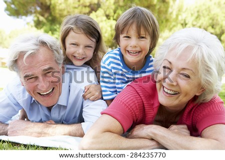 Grandparents And Grandchildren In Park Together