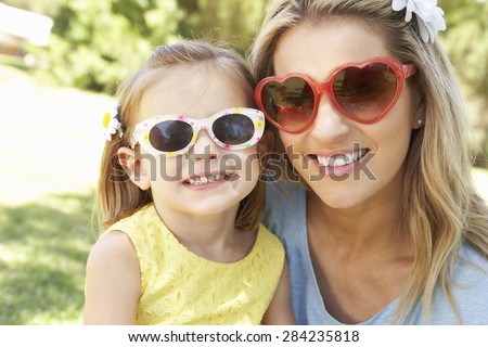 Mother And Daughter Playing In Garden