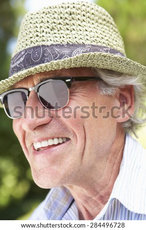 Head And Shoulders Portrait Of Smiling Senior Man With Sun Hat