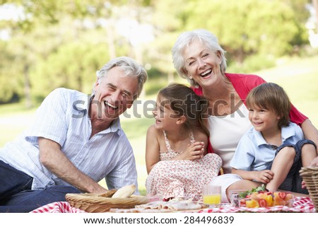 Grandparents And Grandchildren Enjoying Picnic Together