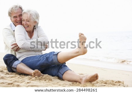 Senior Couple Sitting On Beach Together