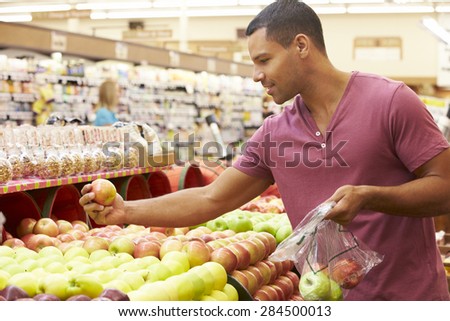 Man At Fruit Counter In Supermarket