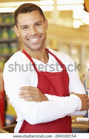Male Cashier At Supermarket Checkout