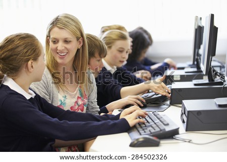Teacher And Pupil In School Computer Class