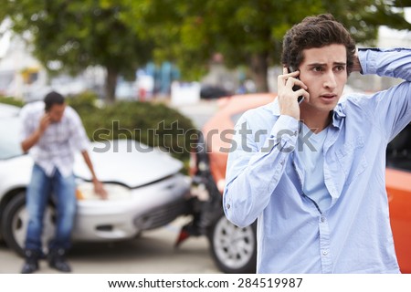 Teenage Driver Making Phone Call After Traffic Accident
