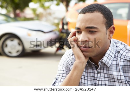 Worried Male Driver Sitting By Car After Traffic Accident