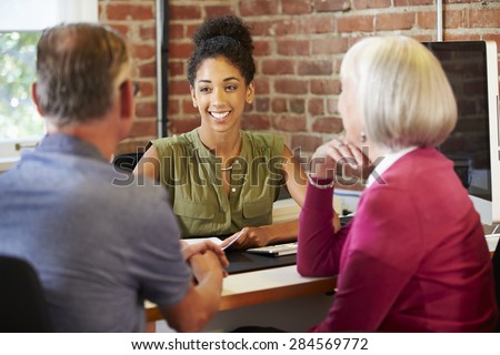 Senior Couple Meeting With Financial Advisor In Office