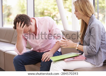 Depressed College Student Talking To Counselor