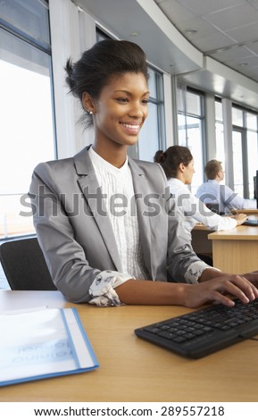 Smiling Worker In Busy Office