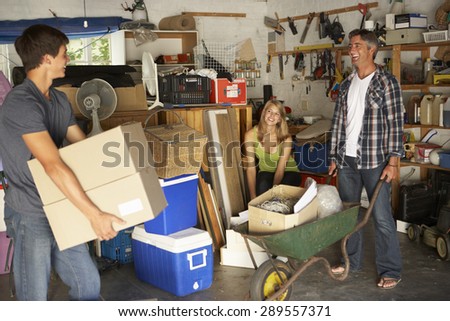 Teenage Family Clearing Garage For Yard Sale