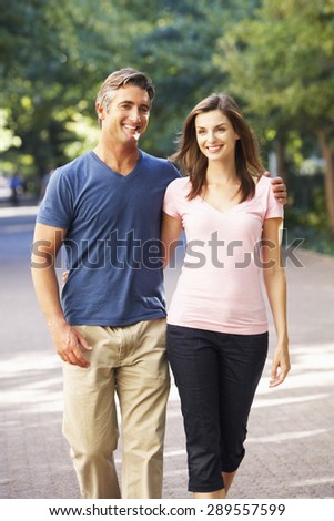 Romantic Couple Walking Through Summer Park