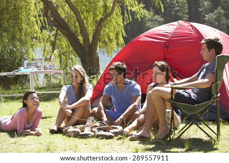 Group Of Young People On Camping Holiday Together
