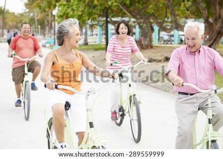 Group Of Senior Friends Having Fun On Bicycle Ride