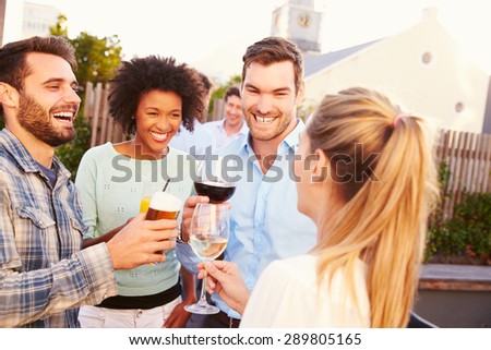 Group of friends drinking at a rooftop bar