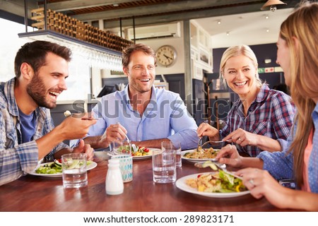 A group of friends eating at a restaurant