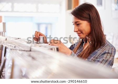 Woman looking through records at a record shop
