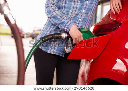 Refuelling a car at a petrol station, close up