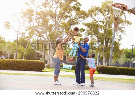 Grandparents And Grandchildren Playing Basketball Together