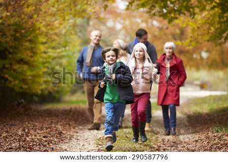 Multl Generation Family Walking Along Autumn Path