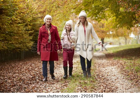 Female Multl Generation Family Walking Along Autumn Path