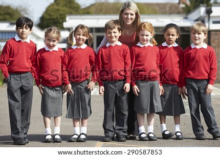 Elementary School Pupils With Teacher In Playground