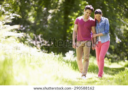 Young Couple Walking In Summer Countryside