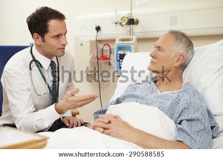 Doctor Sitting By Male Patient\'s Bed In Hospital