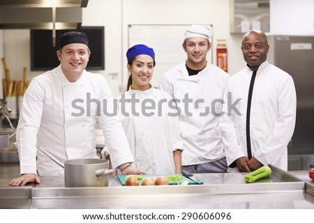 Portrait Of Teacher With Students In College Catering Class