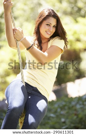 Teenage Girl Having Fun On Rope Swing