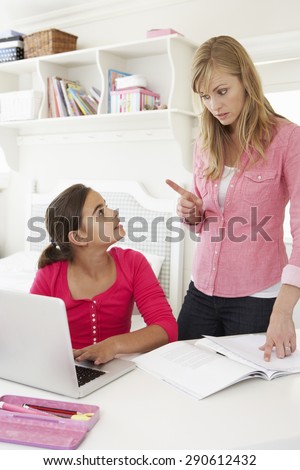 Unhappy Mother Telling Off Daughter For Not Doing Homework