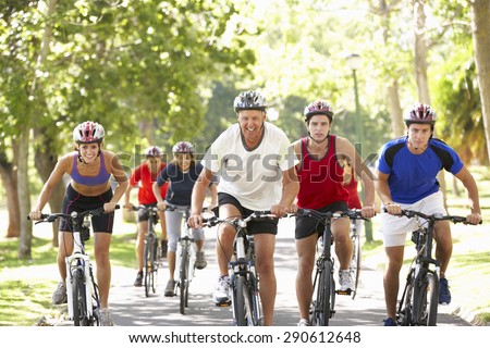 Group Of Cyclists On Cycle Ride Through Park