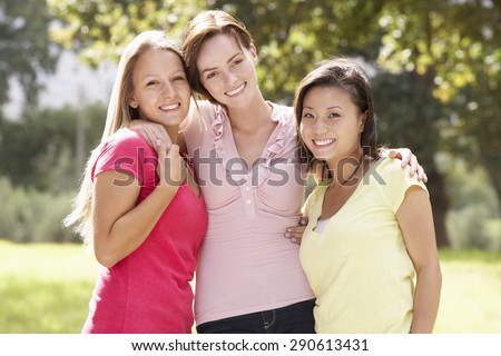 Group Of Three Female Friends Walking Through Countryside
