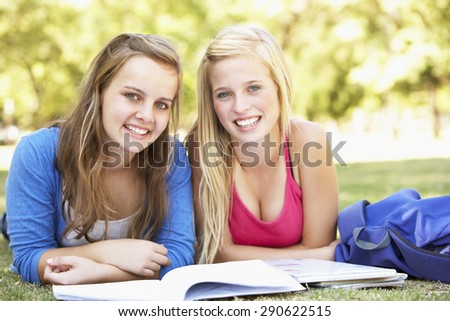 Teenage Girls Studying In Park