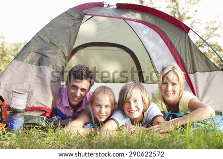 Middle Aged Family On Camping Holiday In Countryside