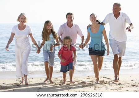 Three Generation Family Having Fun On Beach