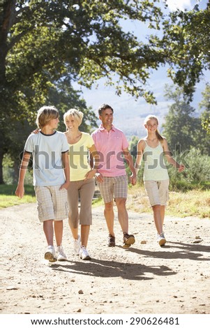 Middle Aged Family Walking Through Countryside