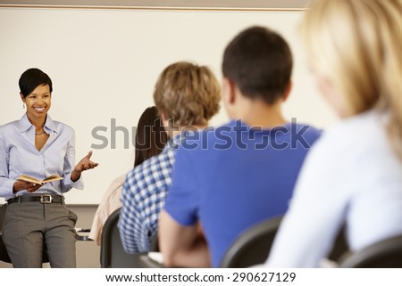 African American teacher teaching at front of class