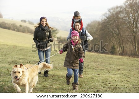 Family and dog on country walk in winter